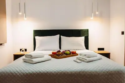 a bed with a bowl of fruit and towels on it at Villa Vriko in Agia Marina Nea Kydonias