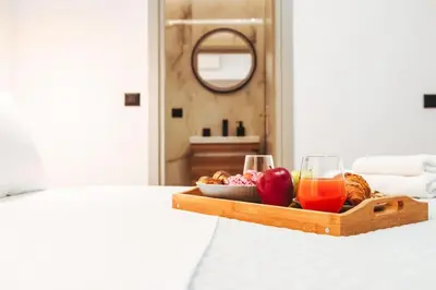 a tray of fruit and juice and glasses on a bed at Villa Vriko in Agia Marina Nea Kydonias