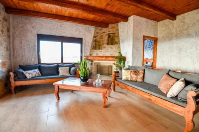 a living room with couches and a table at VILLA DEMETRA in Kissamos
