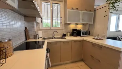 a kitchen with a sink and a microwave at What a View Villa - Amazing Sea & Sunset Panorama with Pool in Chania Town