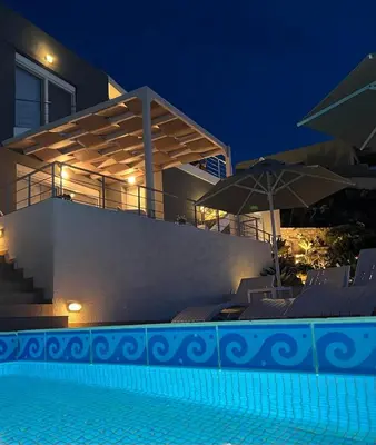 a house with a swimming pool at night at What a View Villa - Amazing Sea & Sunset Panorama with Pool in Chania Town