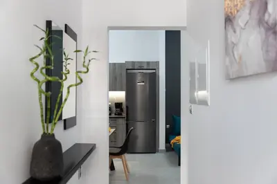 a kitchen with a refrigerator and a vase with a plant at Peggy's house by 8essentially in Chania Town