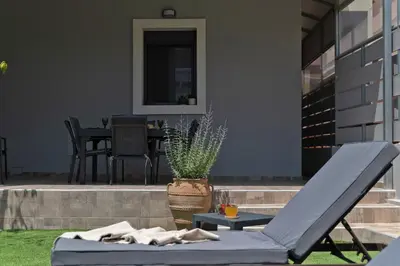 a patio with a chair and a table at Peggy's house by 8essentially in Chania Town