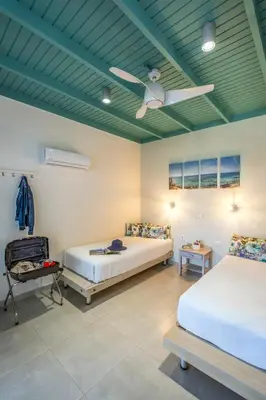 two beds in a room with a green ceiling at Paradisos in Frangokastello