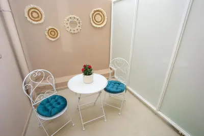 a table with two chairs and a table with a plant on it at Casa De Potie in Chania Town