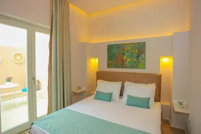 a bedroom with a bed and a painting on the wall at Casa De Potie in Chania Town
