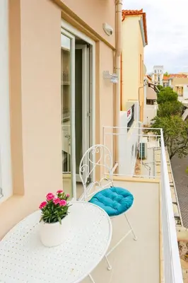 a white table and chair on a balcony at Casa De Potie in Chania Town