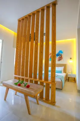 a bedroom with a bed and a bench in a room at Casa De Potie in Chania Town
