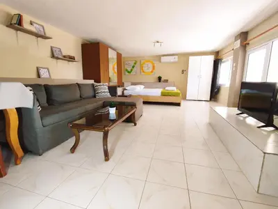 a living room with a couch and a table at Village house with a nice garden in Stérnai