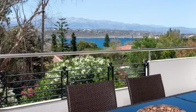 a balcony with two chairs and a view of the water at Luxury Seaside Villa Plumeria ,50m to Sandy Beach, Chania in Tersanas