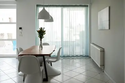 a dining room with a table and chairs and a window at The Teacher's Home 2 minutes away from the beach in Galatás