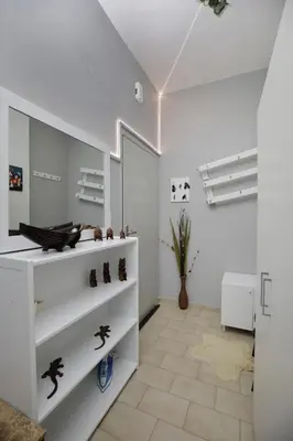 a white room with white shelves and a vase at central cozy and lovely house in Chania Town