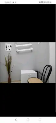 a room with a table and two chairs and a white table at central cozy and lovely house in Chania Town