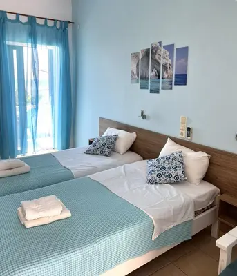 two beds sitting next to each other in a bedroom at Milos Alexandra Studio in Frangokastello