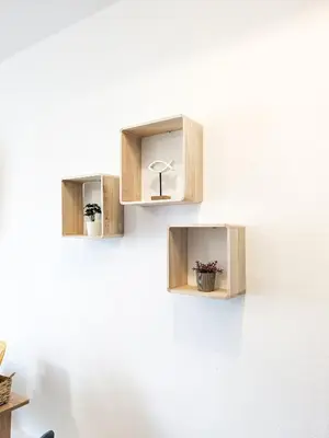 three wooden shelves on a wall with flowers in them at Cozy Apartment in Chania Town
