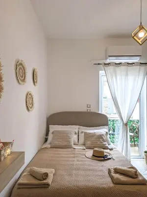 a bedroom with a large bed with towels on it at Cozy Apartment in Chania Town