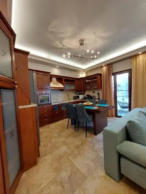 a kitchen and living room with a couch and a table at Rika's Sea View Apartment in Chania Town
