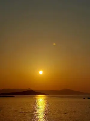 an image of the sun setting over the water at Rika's Sea View Apartment in Chania Town
