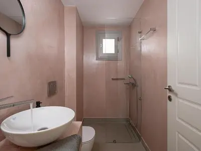 a bathroom with a sink and a toilet and a shower at La Torre Villa in Palio Gerani