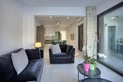 a living room with a couch and a chair at Casa Cafenio by PosarelliVillas in Nípos