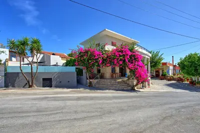 a house with pink flowers on the front of it at Casa Cafenio by PosarelliVillas in Nípos