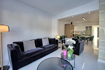 a living room with black couches and a glass table at Casa Cafenio by PosarelliVillas in Nípos