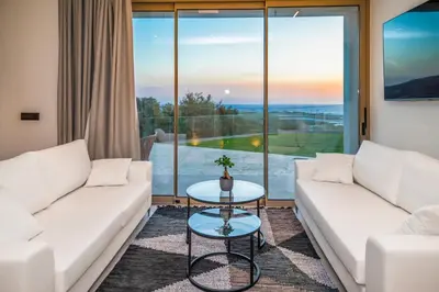 a living room with white couches and a table at Falasarna's Dream in Kissamos