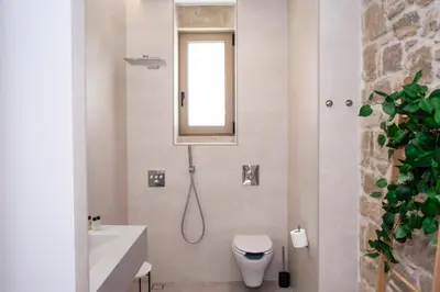 a bathroom with a shower and a toilet and a sink at Falasarna's Dream in Kissamos