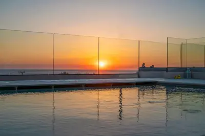 a swimming pool with the sunset in the background at Falasarna's Dream in Kissamos