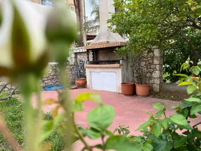 a garage with a white door in a yard at Seaside cozy apartment in Aghii Apostoli
