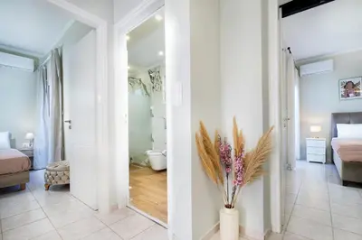 a white room with a vase with flowers in it at Gigis Apartment in Chania Town