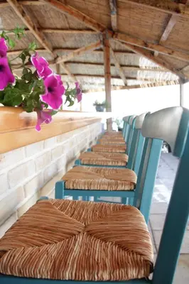 a row of chairs with pink flowers on them at Hotel Porto Loutro on the Hill in Loutro