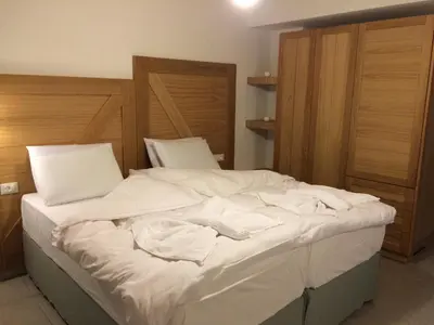a bedroom with a bed with white sheets on it at Hotel Porto Loutro on the Hill in Loutro