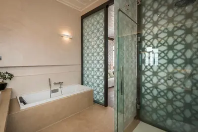a bathroom with a tub and a glass shower stall at Ambassadors Residence Boutique Hotel in Chania Town