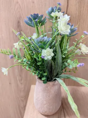 a vase filled with white and blue flowers on a table at Fanouris Luxury Apartments in Chania Town