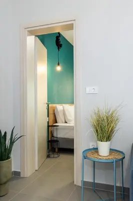 a room with a bed and a table with a bed at Fanouris Luxury Apartments in Chania Town