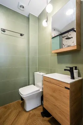 a bathroom with a toilet and a sink and a mirror at Fanouris Luxury Apartments 2 in Chania Town