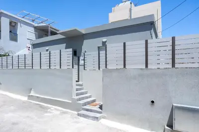 a house with stairs on the side of it at Fanouris Luxury Apartments 2 in Chania Town