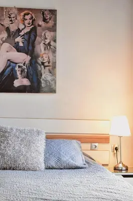 a bedroom with a large painting above a bed at Cozy rooms at the old Venetian Harbor, Chania Town in Chania Town