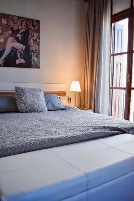 a bedroom with a bed and a large window at Cozy rooms at the old Venetian Harbor, Chania Town in Chania Town