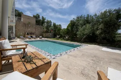 a swimming pool in the middle of a yard at Freya's Royal Estate, Kissamos in Khairethianá