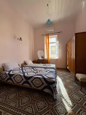 a bedroom with two beds and a window at THE NEOCLASSICAL Garden House in Chania Town