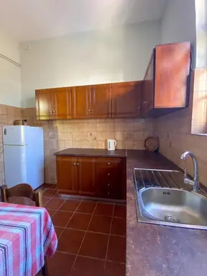 a kitchen with a sink and a refrigerator at THE NEOCLASSICAL Garden House in Chania Town