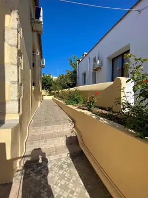 a shadow of a person standing next to a building at THE NEOCLASSICAL Garden House in Chania Town