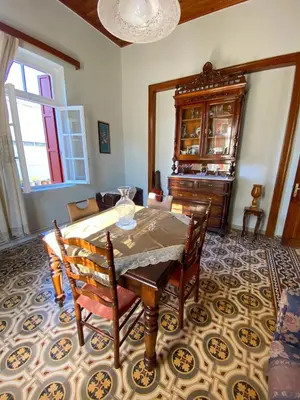 a dining room with a table and chairs in a room at THE NEOCLASSICAL Garden House in Chania Town