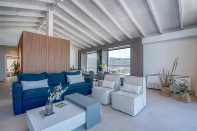 a living room with a blue couch and chairs at Onar Villa - staying in comfort in Kissamos