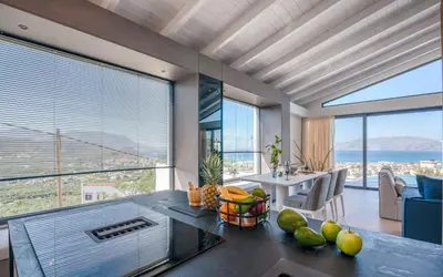 a kitchen with a table with fruit on the counter at Onar Villa - staying in comfort in Kissamos