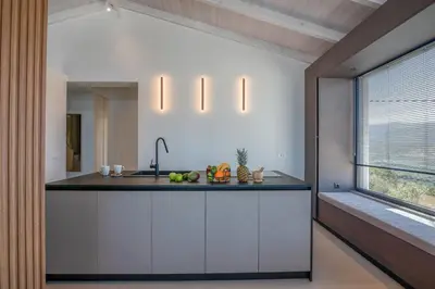 a kitchen with a counter with a sink and a window at Onar Villa - staying in comfort in Kissamos