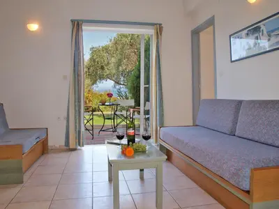 a living room with a couch and a table at Artemis Apartments in Kalyves