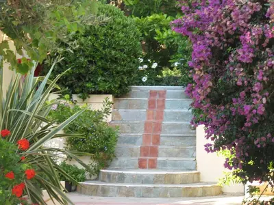 a set of stairs with a red stripe on it at Artemis Apartments in Kalyves